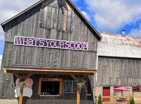 a barn with a sign that says what's your scoop?.