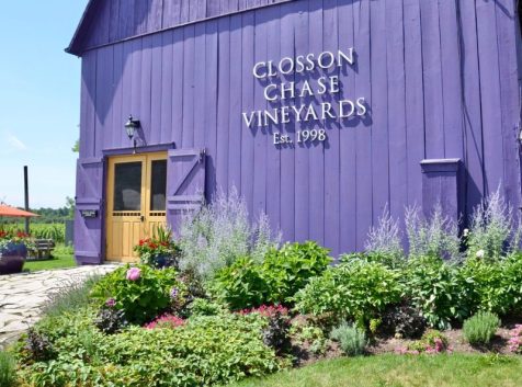 a purple building with a sign that says close chase vineyards.