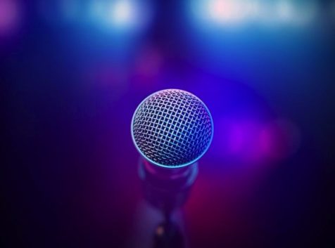 a microphone in a dark room with bright lights.