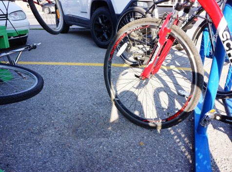 a close up of a bike parked next to a car.