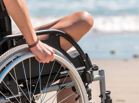 a person in a wheelchair on a beach.