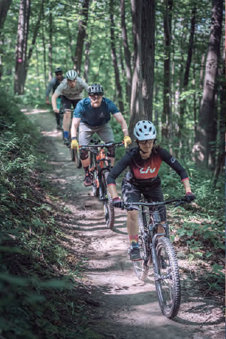a group of people riding bikes down a trail.