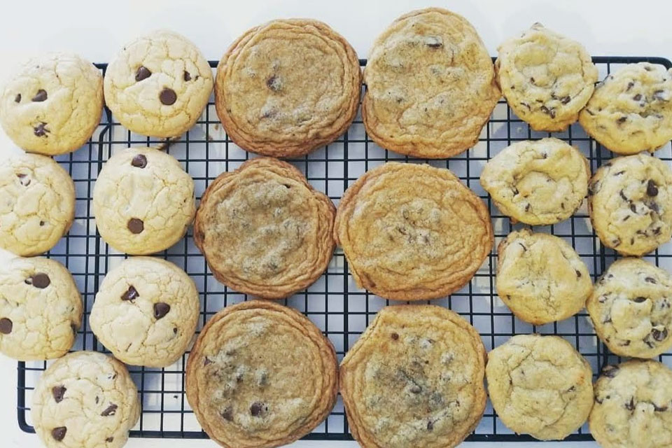 a cooling rack filled with chocolate chip cookies.