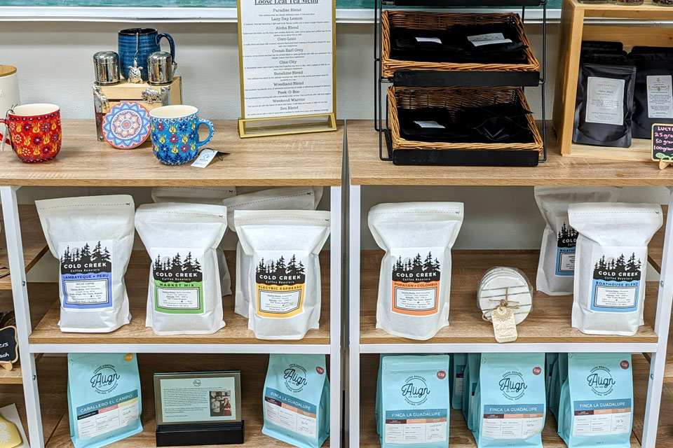 a display of coffee bags on a shelf.
