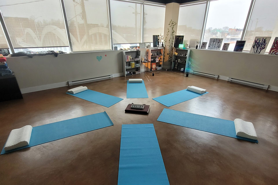 a room with yoga mats and a cell phone on the floor.