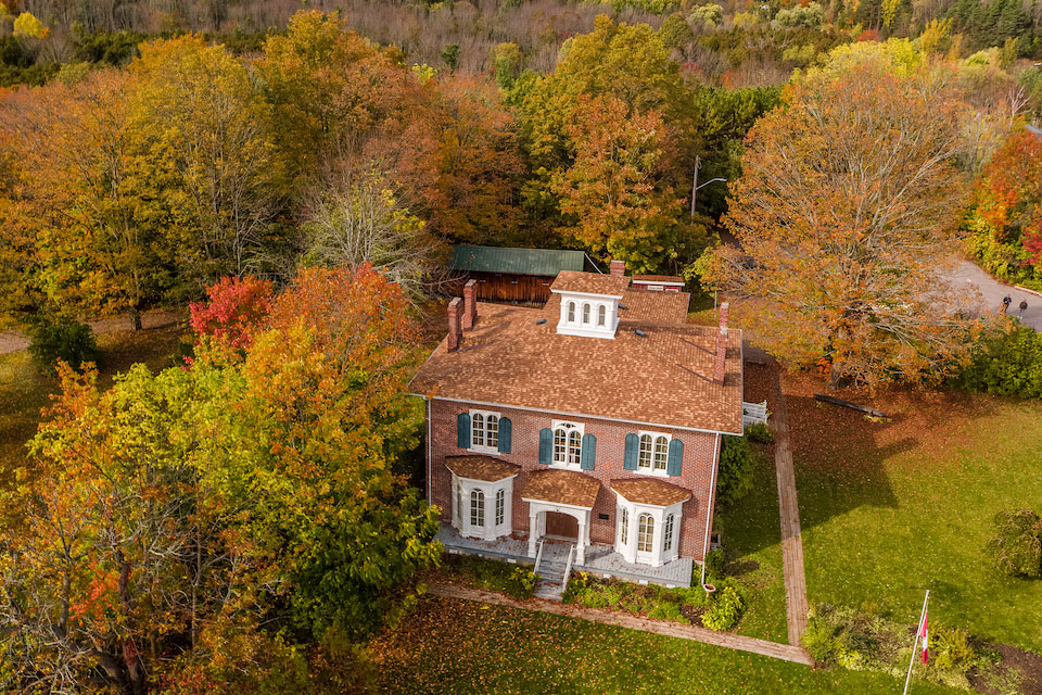 an aerial view of a house surrounded by trees.