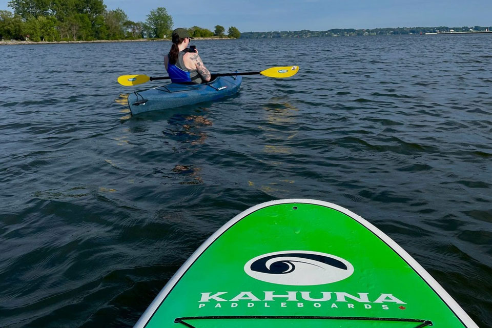 a person in a kayak paddling on the water.