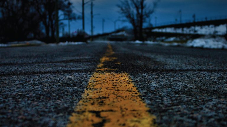 a yellow line painted on the side of a road.