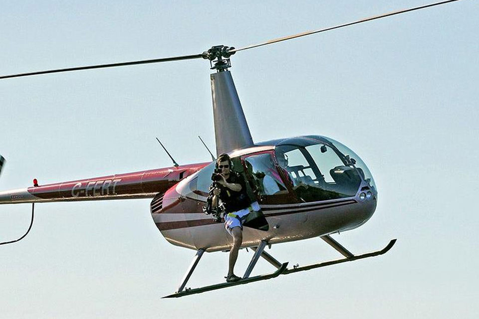 a person sitting on a chair in a helicopter.