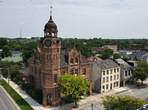 aerial photo of an old sandstone building with a clocktower