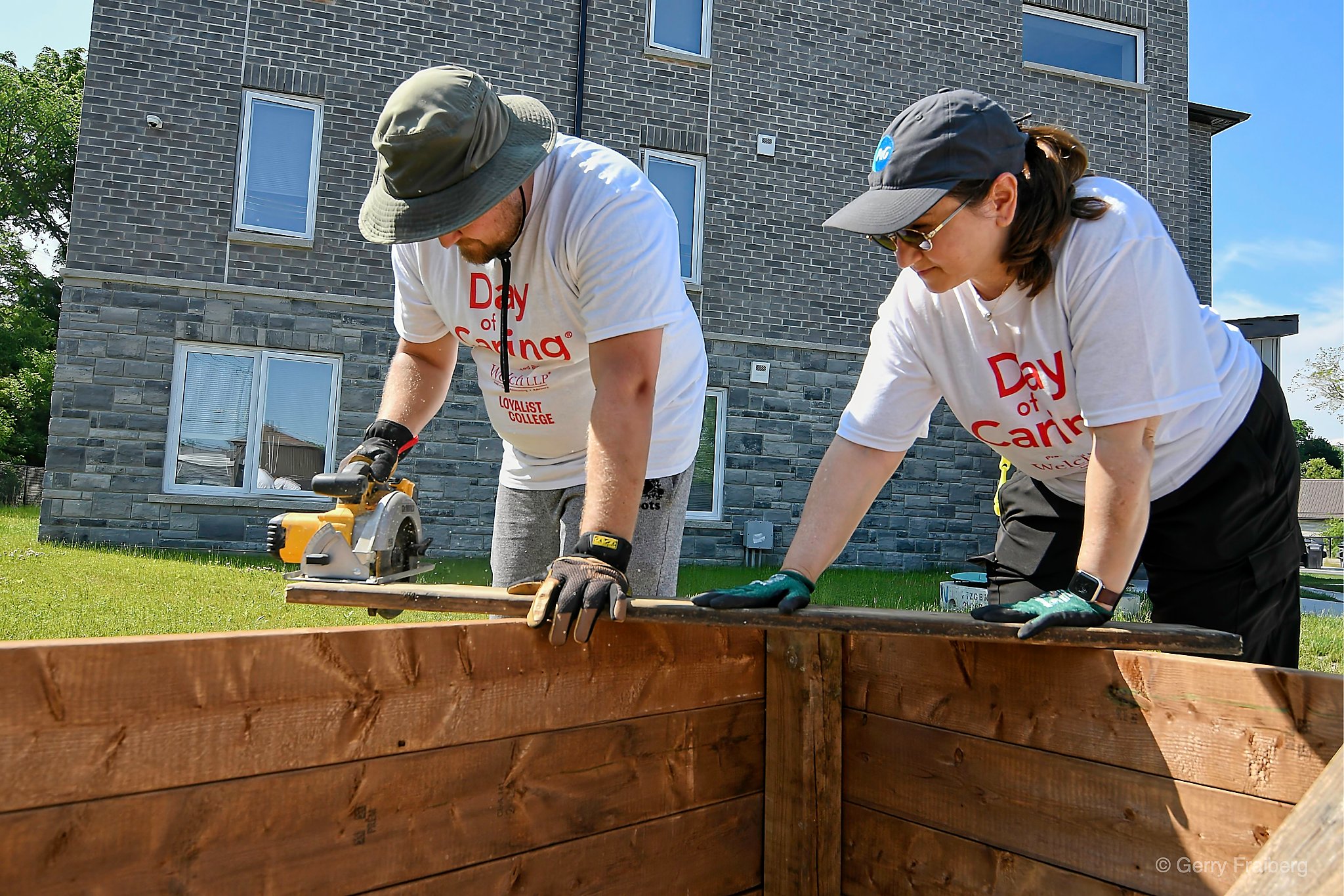 volunteers working on building a garden box