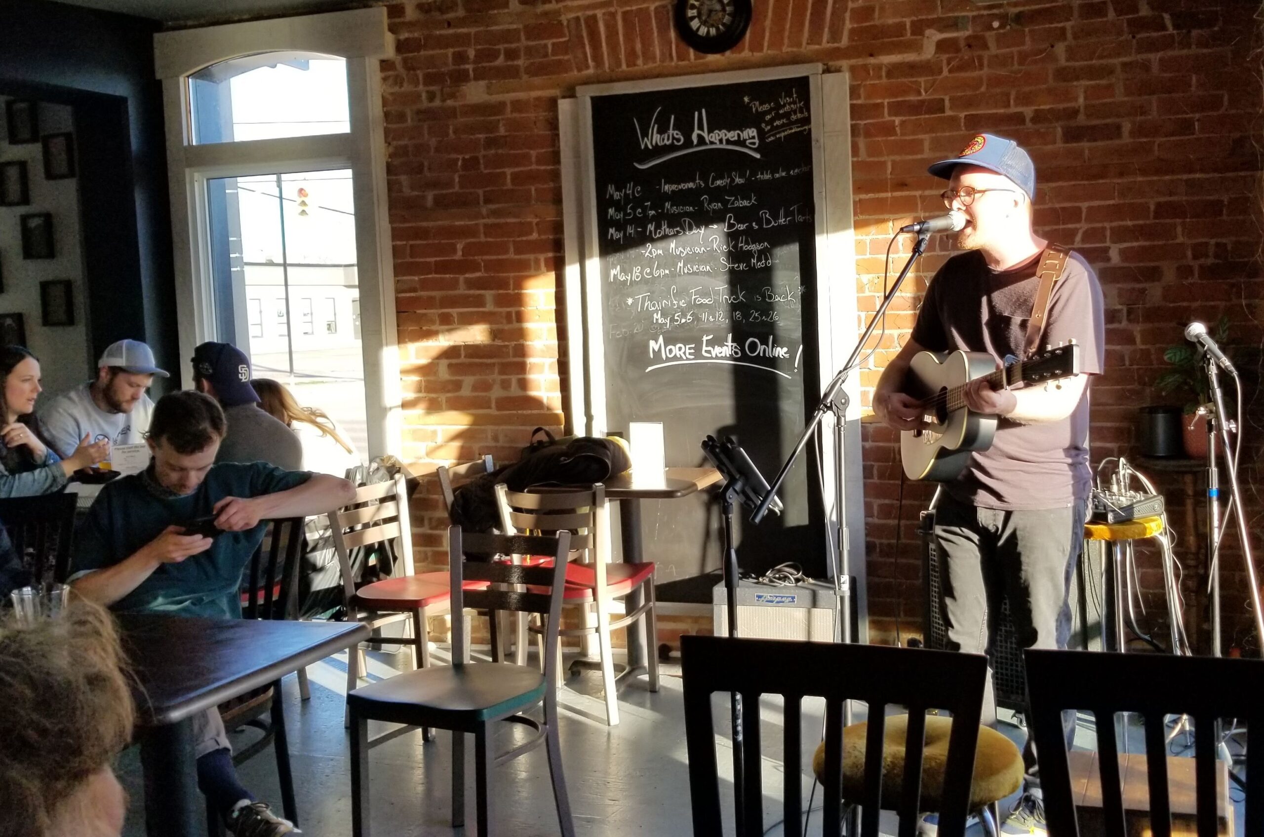 photo of a performer at the brewery. Holding guitar and singing