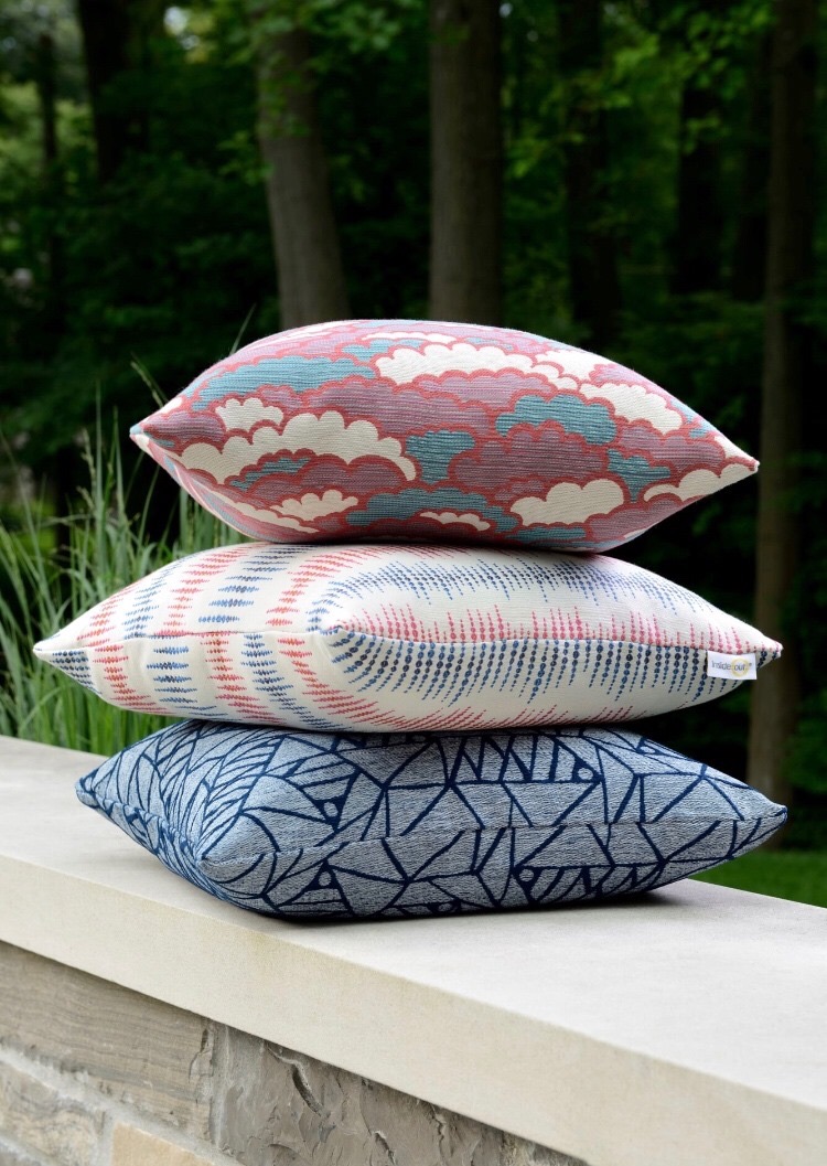 photo of 3 patterned pillows stacked.