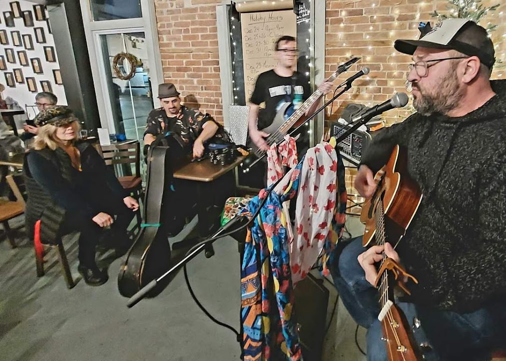 open mic night photo, shows musicians playing in a pub setting.