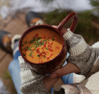photo of hands holding a cup of soup