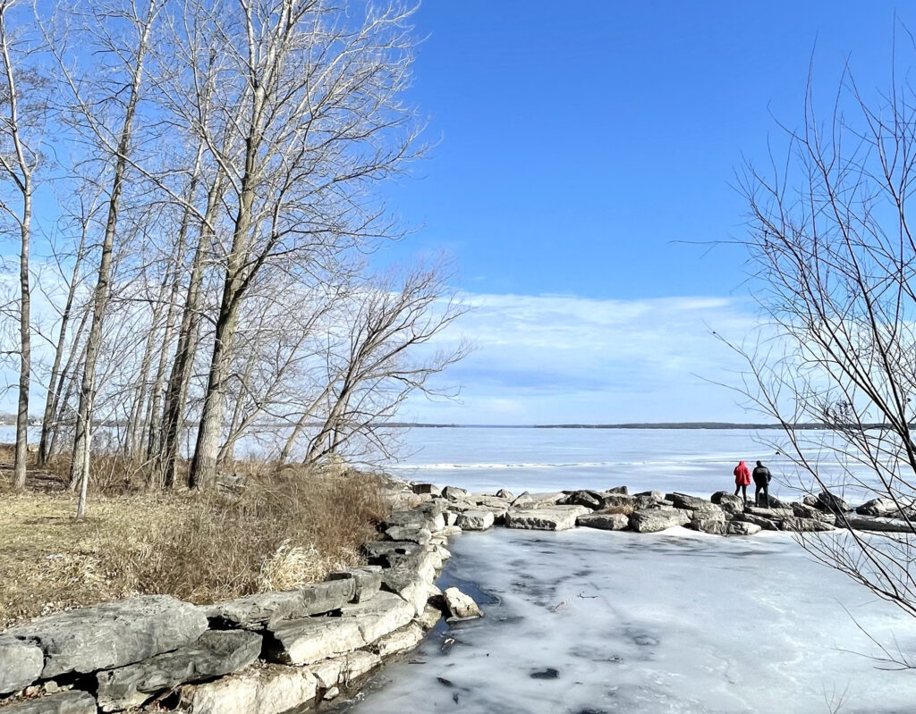 rocky shoreline along a frozen body of water