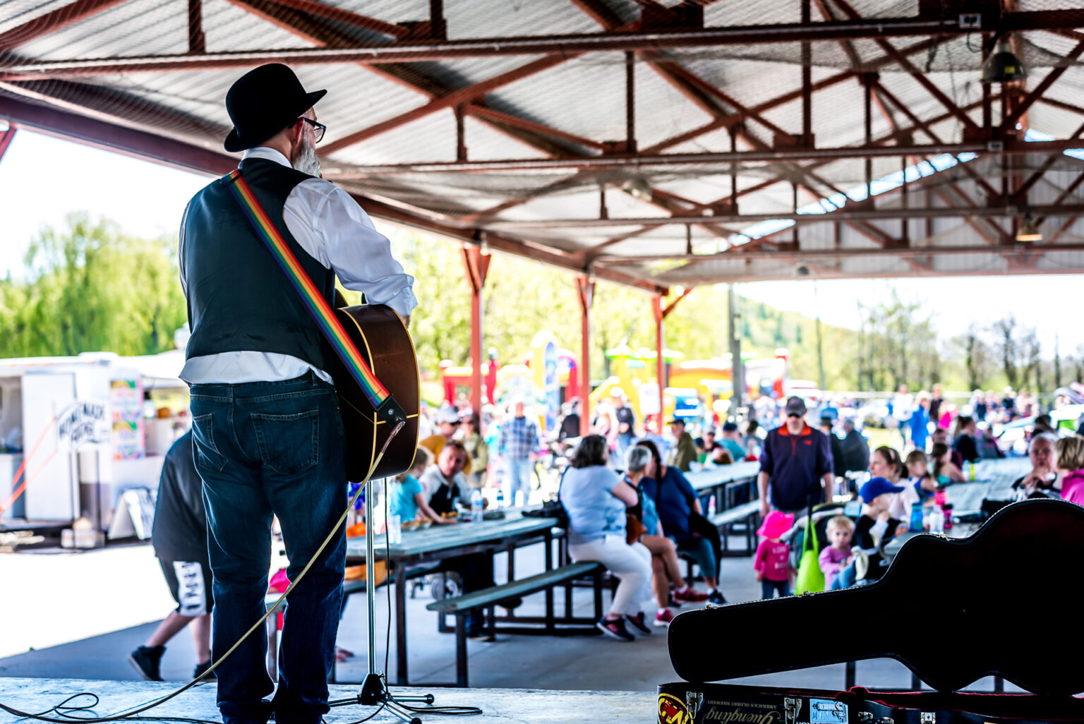 Photo of man performing with an acoustic guitar at Frankford's tourist park.