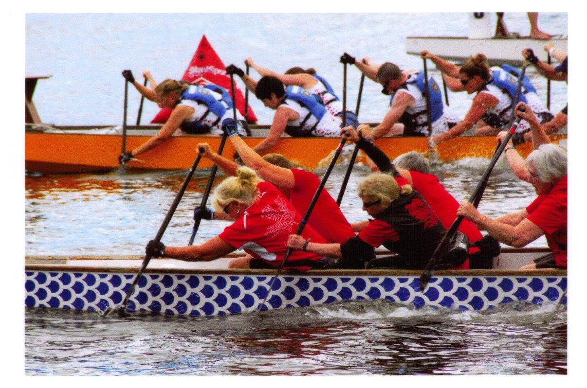 Photo of people rowing at a dragon boat competition.