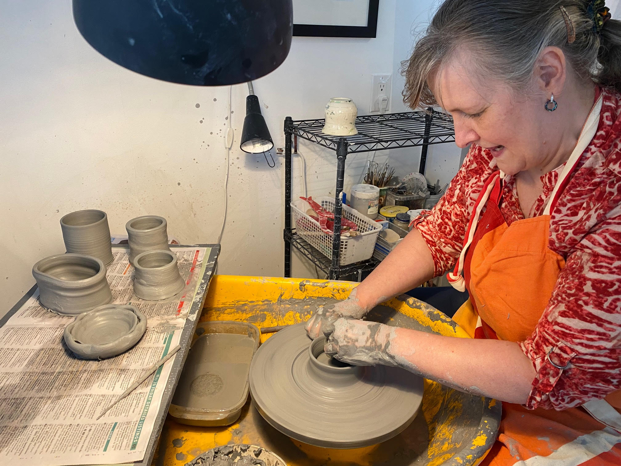 Photo of a person making pottery.