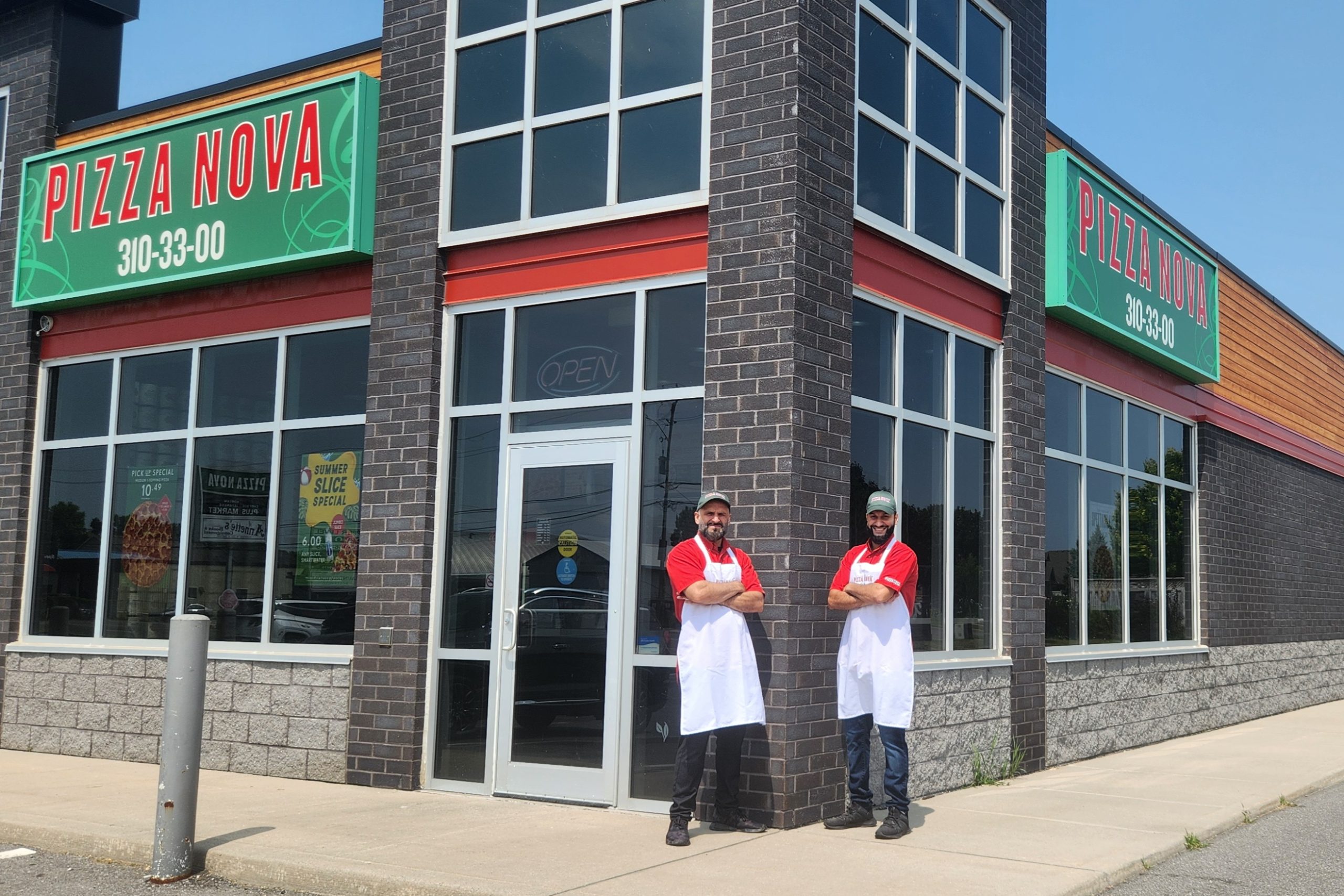 Photo of workers in front of Belleville Pizza Nova.