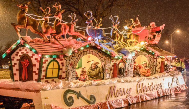 Photo of a float at a christmas parade showing a winter village scene.