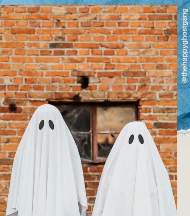 Photo of two people wearing rudimentary ghost costumes.