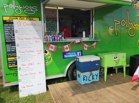 Image of green food truck with sign in front