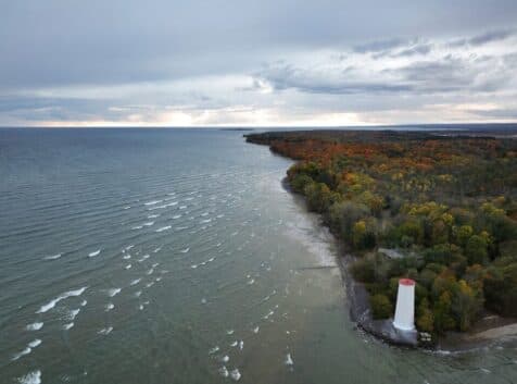 Aerial image of a wooded park with a lighthouse