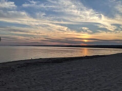 Image of a sunset over the water from the beach