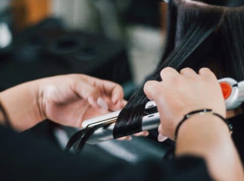 Image of someone curling dark brown hair