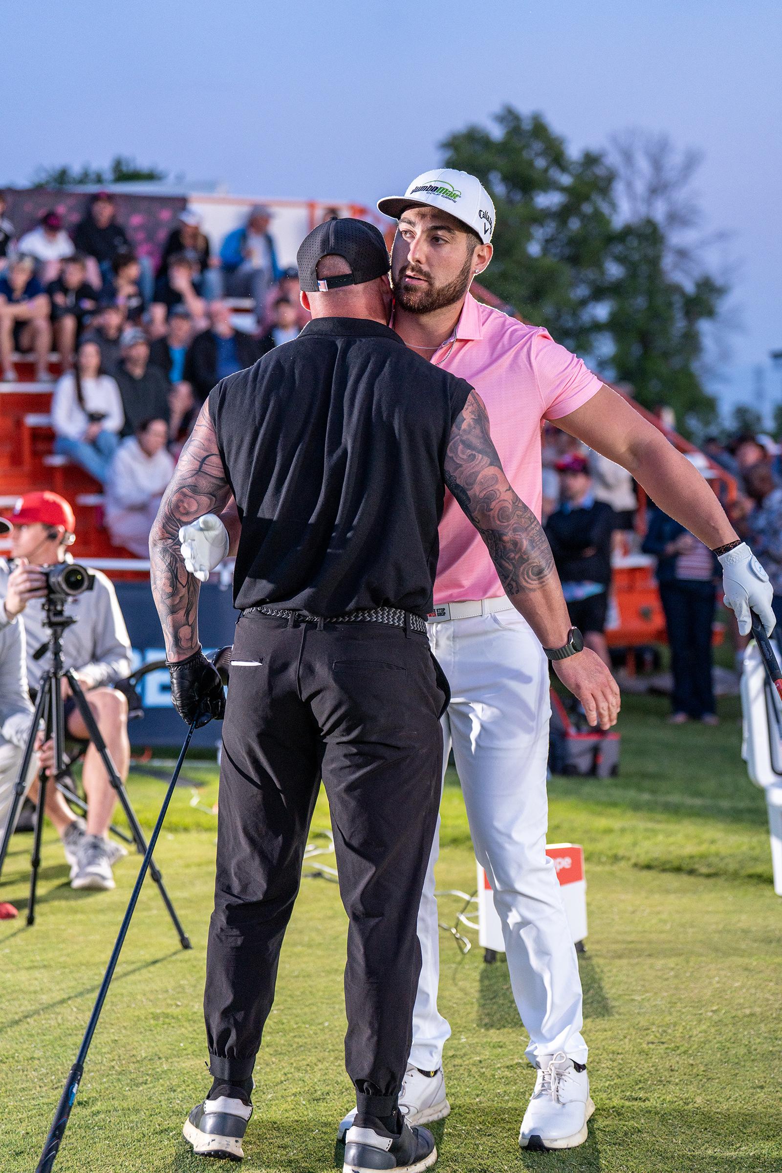 Two golfers about to embrace