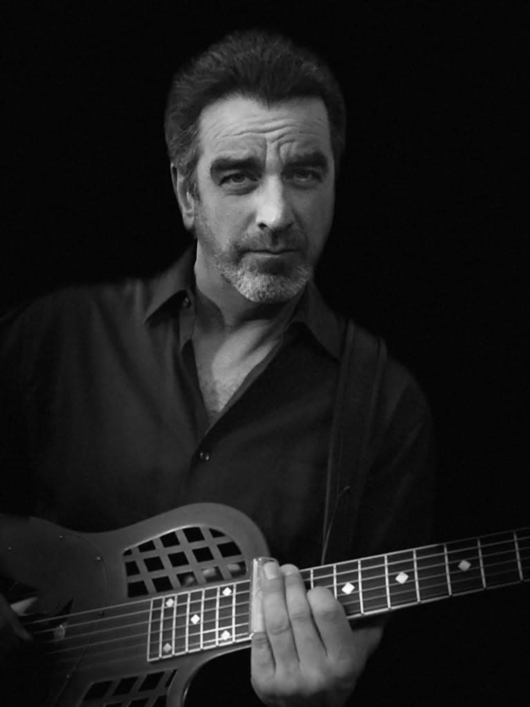 man with guitar in black and white