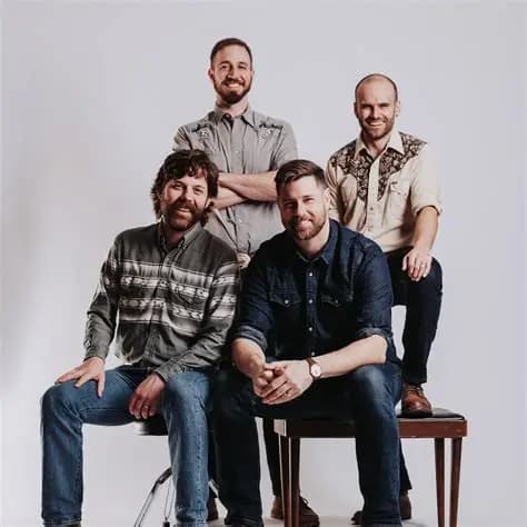 two men sitting two men behind